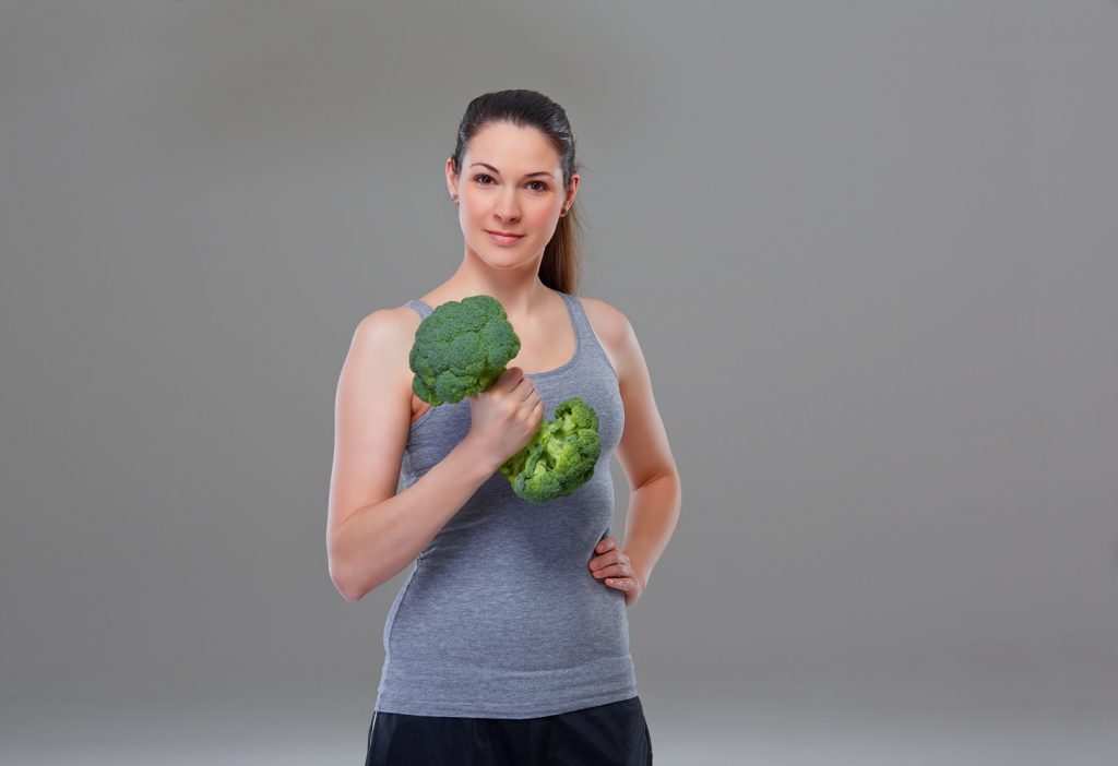 Woman lifting broccoli