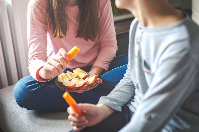 Children eating healthy snacks