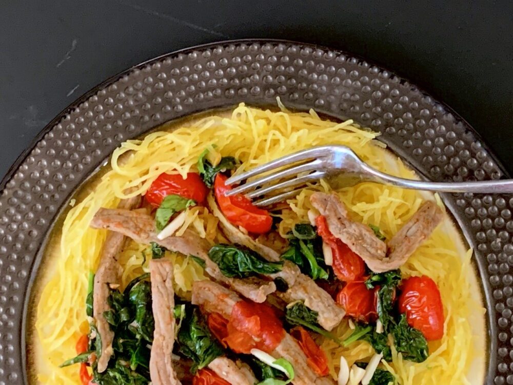 Sauteed beef spinach and tomatoes over roasted spaghetti squash rotated