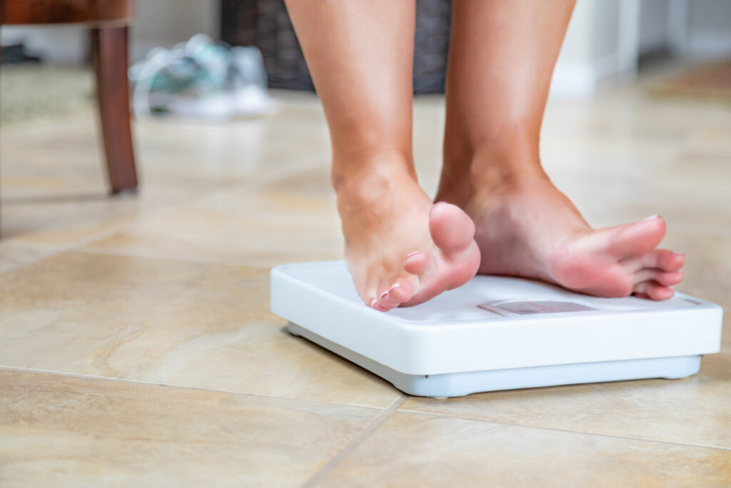 Feet standing on a weight scale